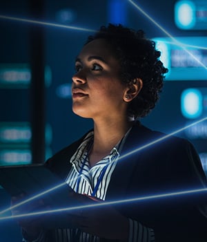 Security professional looking up Surrounded by dark tech background