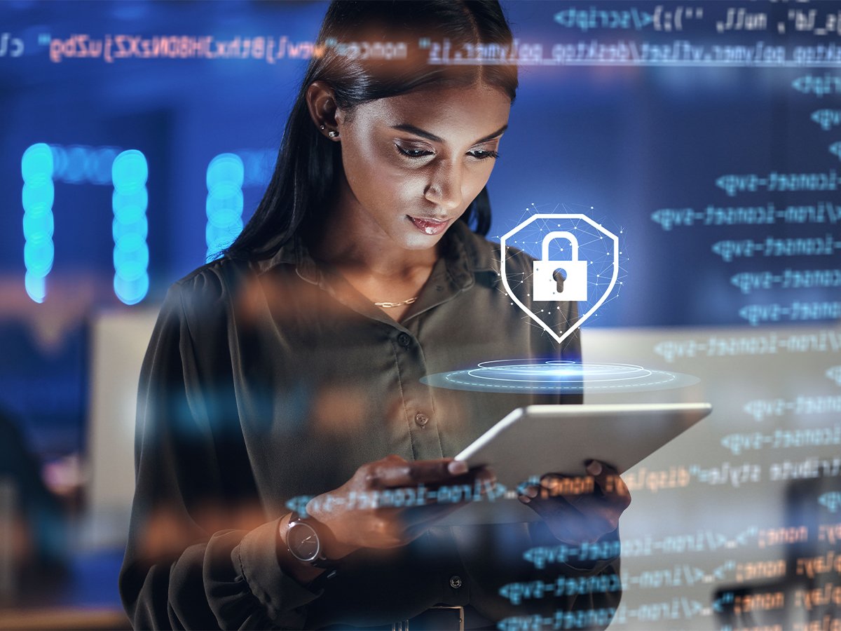 Person holding a tablet with a digital padlock icon and code overlay, representing cybersecurity and data protection.