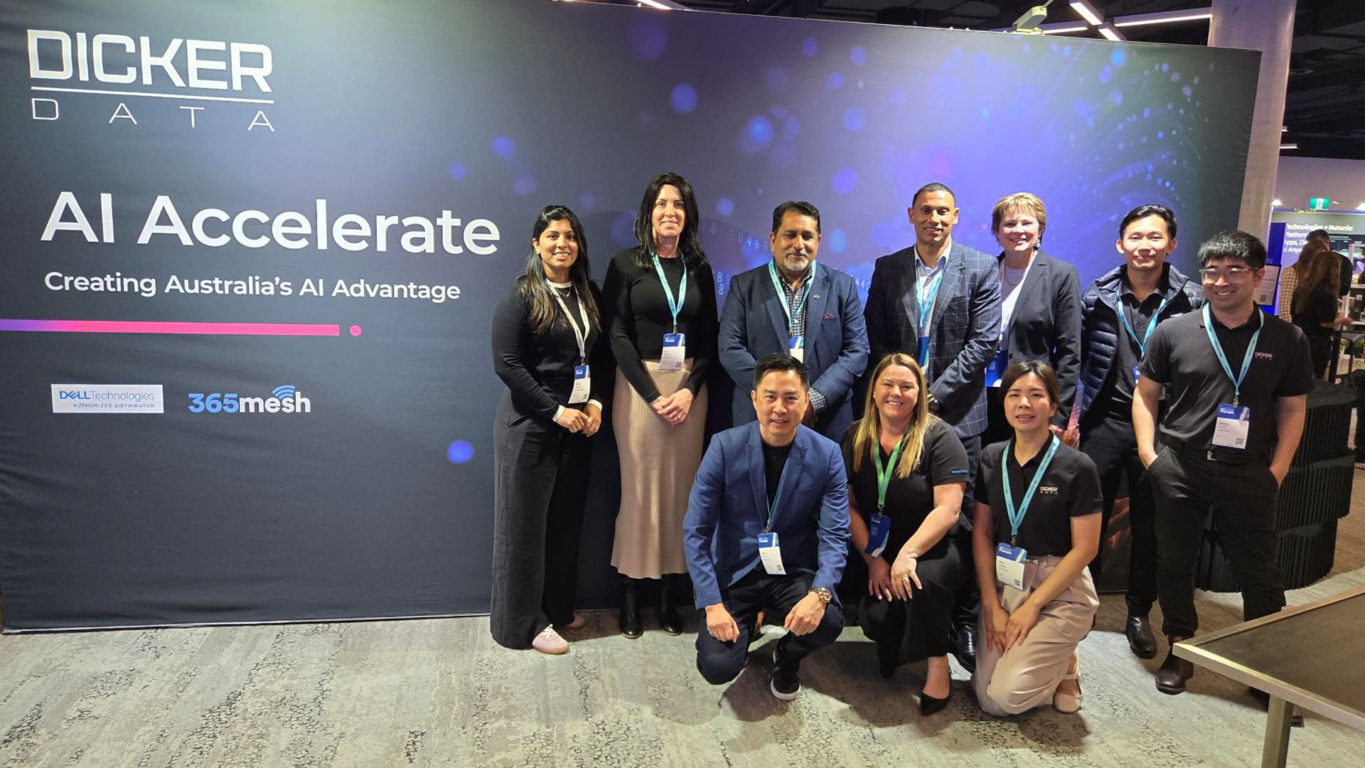 Event group photo in front of a Dicker Data ‘AI Accelerate’ branded display.