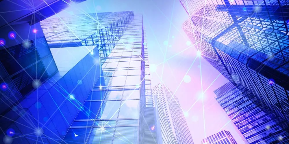 Modern skyscrapers with digital network lines and glowing connection points representing data connectivity.