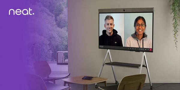 Large video conferencing display on a stand in a modern meeting room.