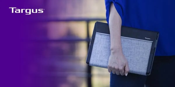 Person holding a slim, fabric-textured laptop case with a Targus logo.