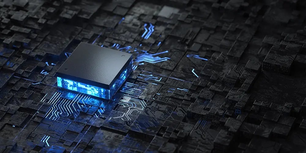 Glowing processor chip on a dark circuit board.