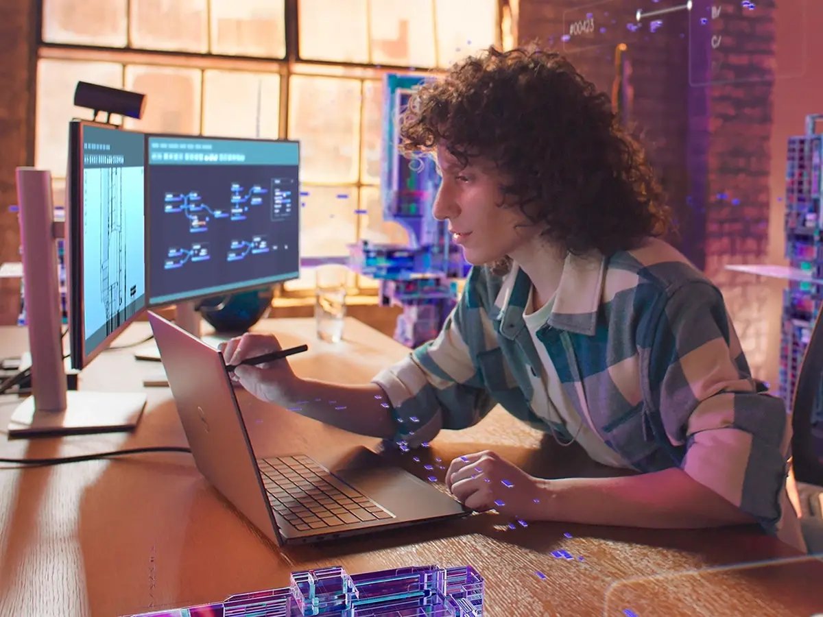 Modern workstation setup with a laptop and dual monitors displaying technical diagrams and code, on a wooden desk in a stylish office.