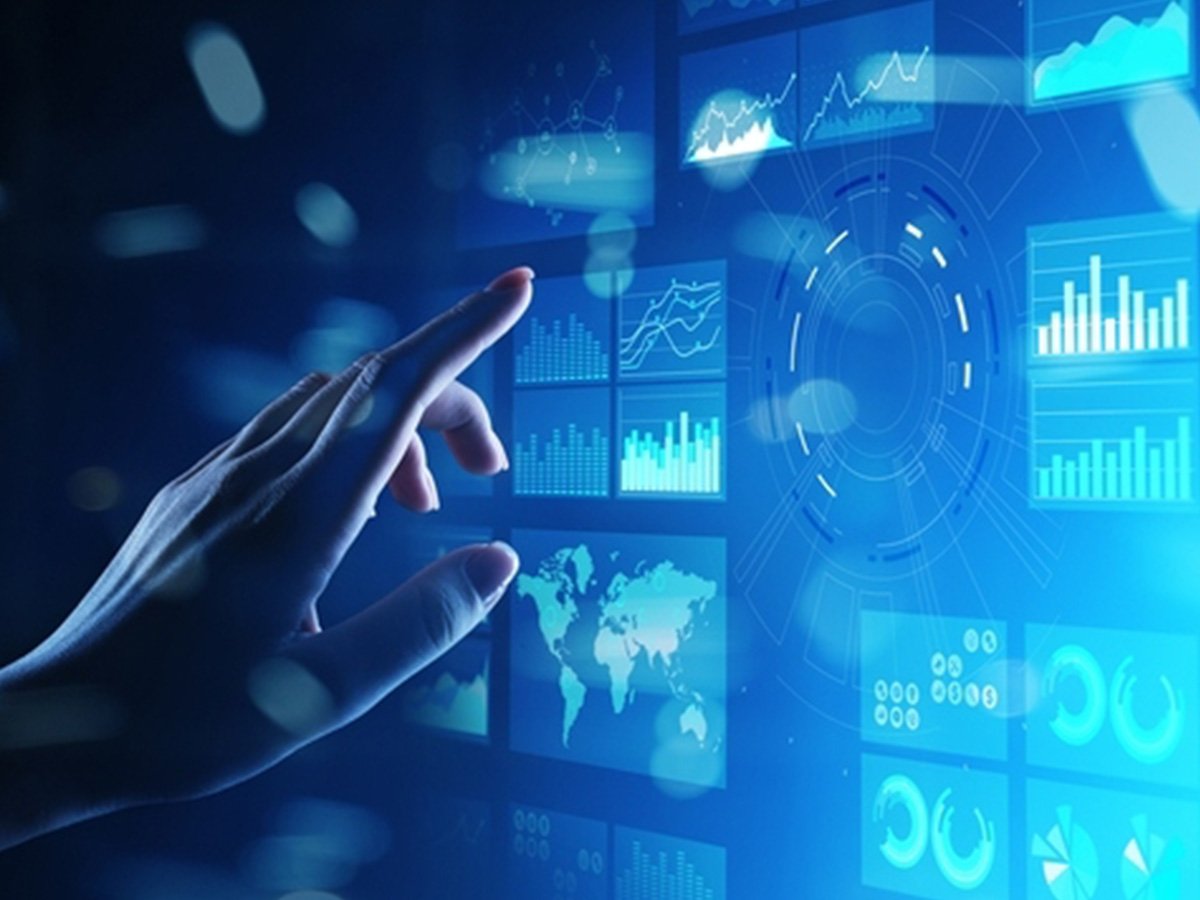 Hand reaching toward a digital screen showing charts, graphs, and a world map.