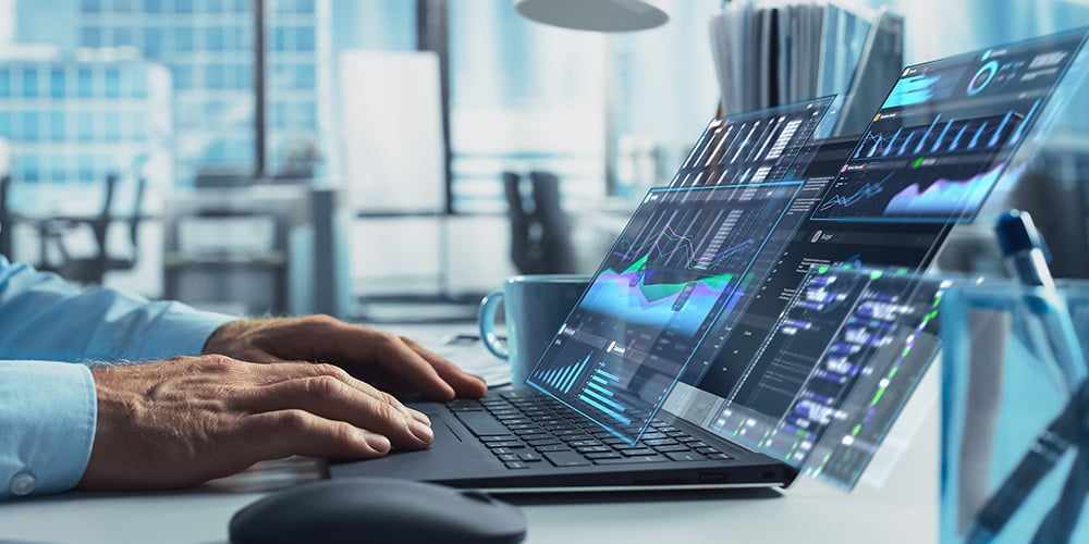 Transparent analytics dashboards floating above a laptop displaying charts, metrics, and trend lines.