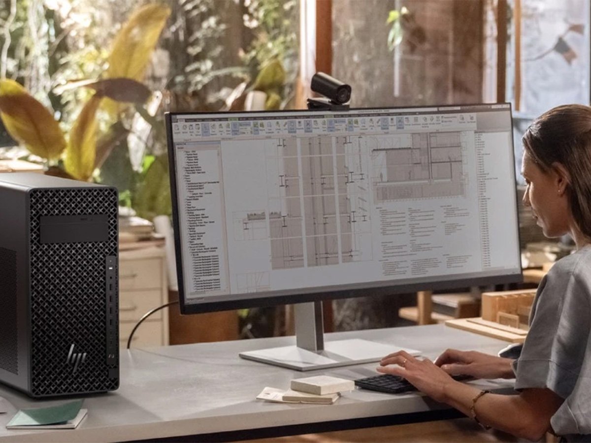 Person working at a large monitor displaying architectural design software.