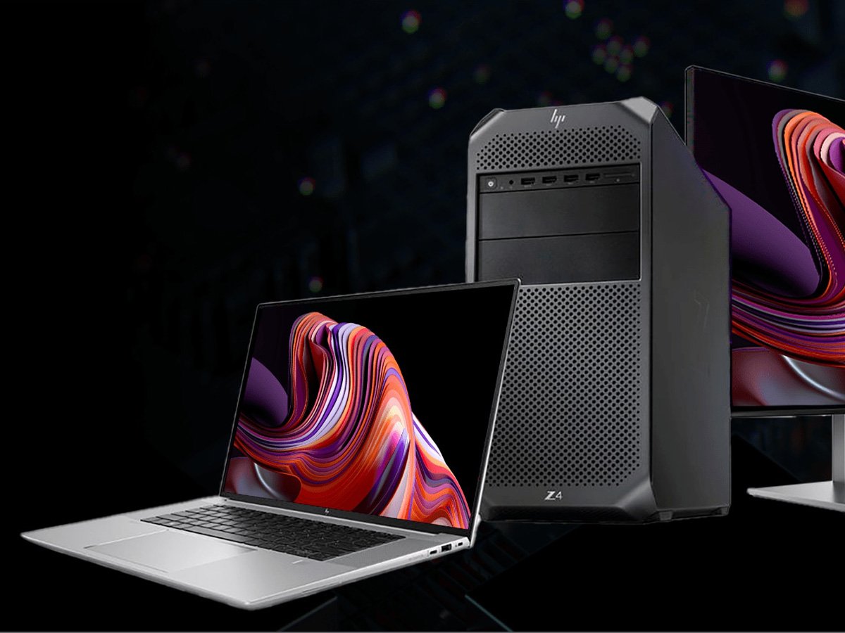 Laptop, desktop tower, and monitor displaying colorful abstract graphics.
