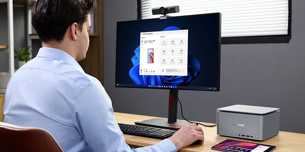 Person using a desktop setup with a monitor showing a device‑connection app.