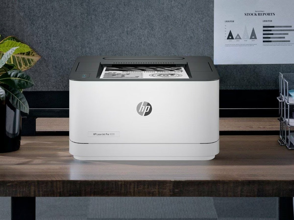 HP LaserJet Pro printer on a wooden desk with printed pages.