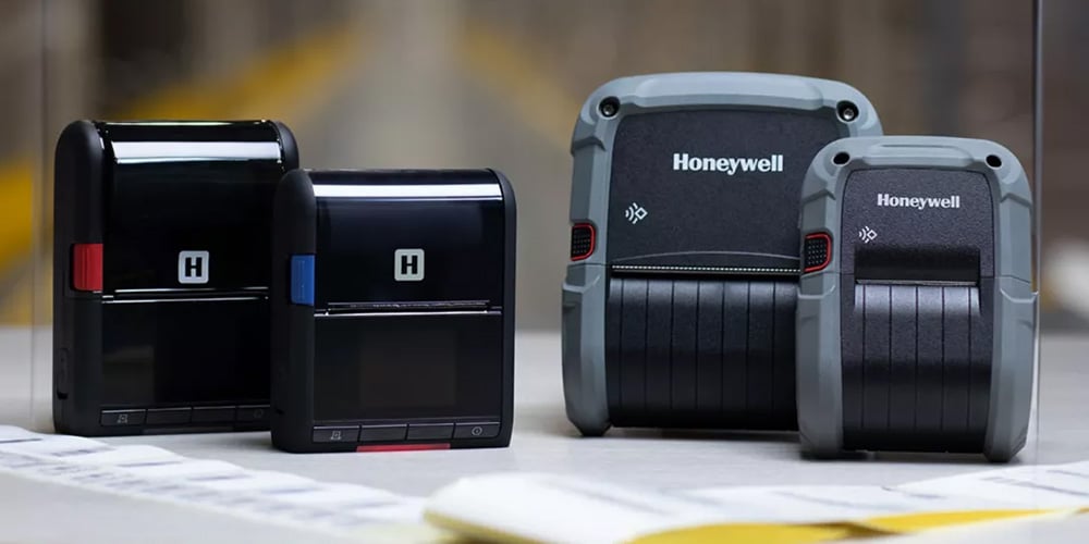 Honeywell portable label printers in different sizes on a desk.
