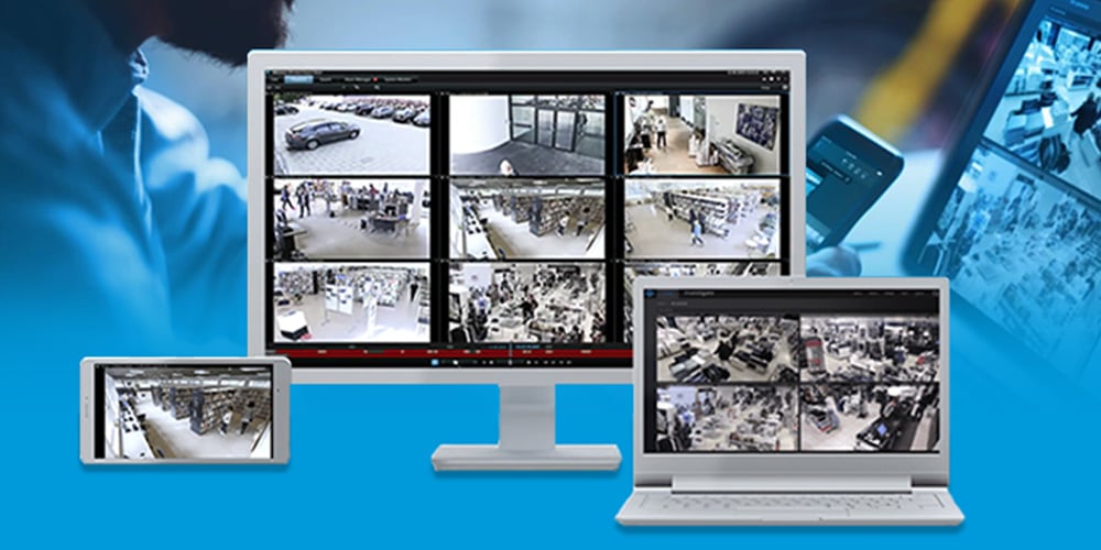 Surveillance camera feeds displayed on a tablet, monitor, and laptop.