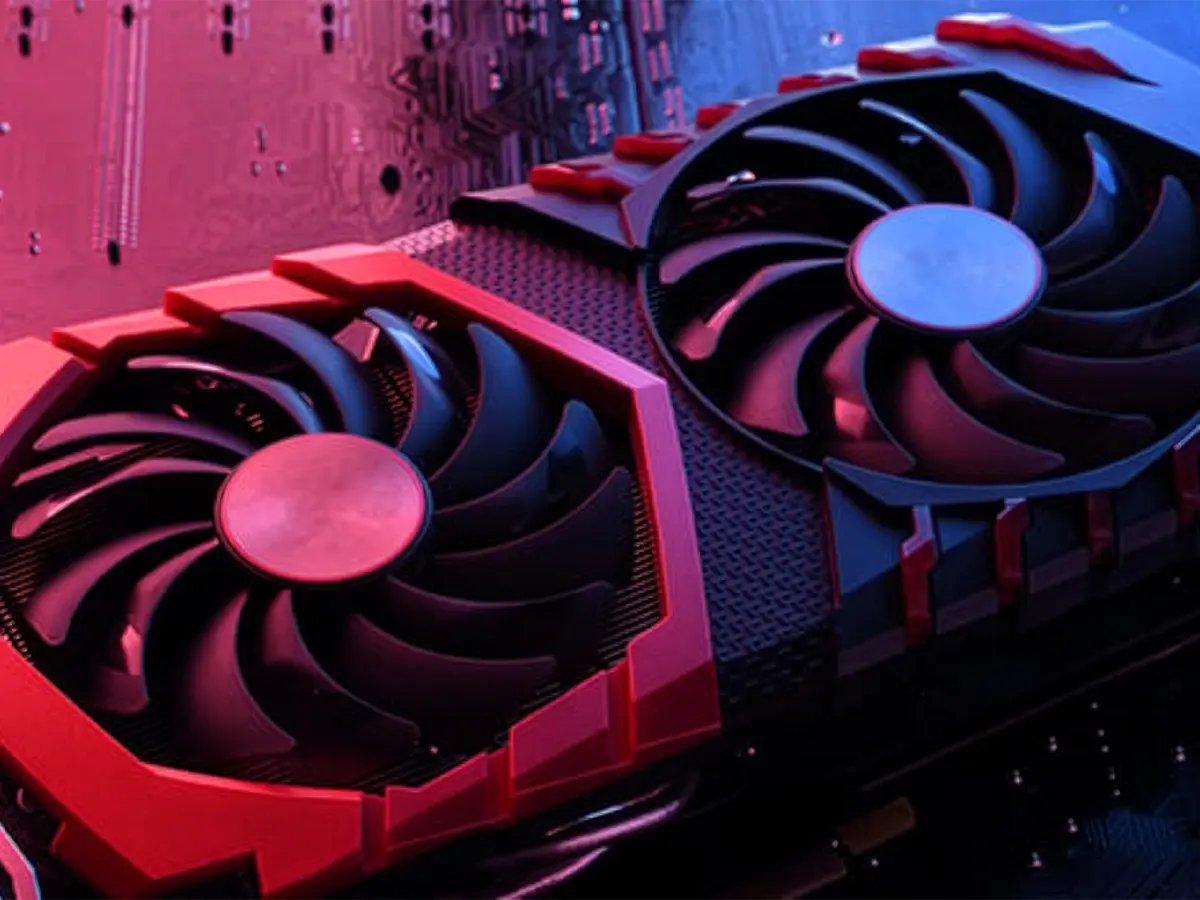 Close‑up of a graphics card with dual cooling fans mounted on a circuit board, lit in red and blue light.