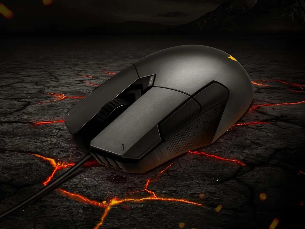 Black wired gaming mouse resting on a cracked, lava‑like surface with glowing orange lines.