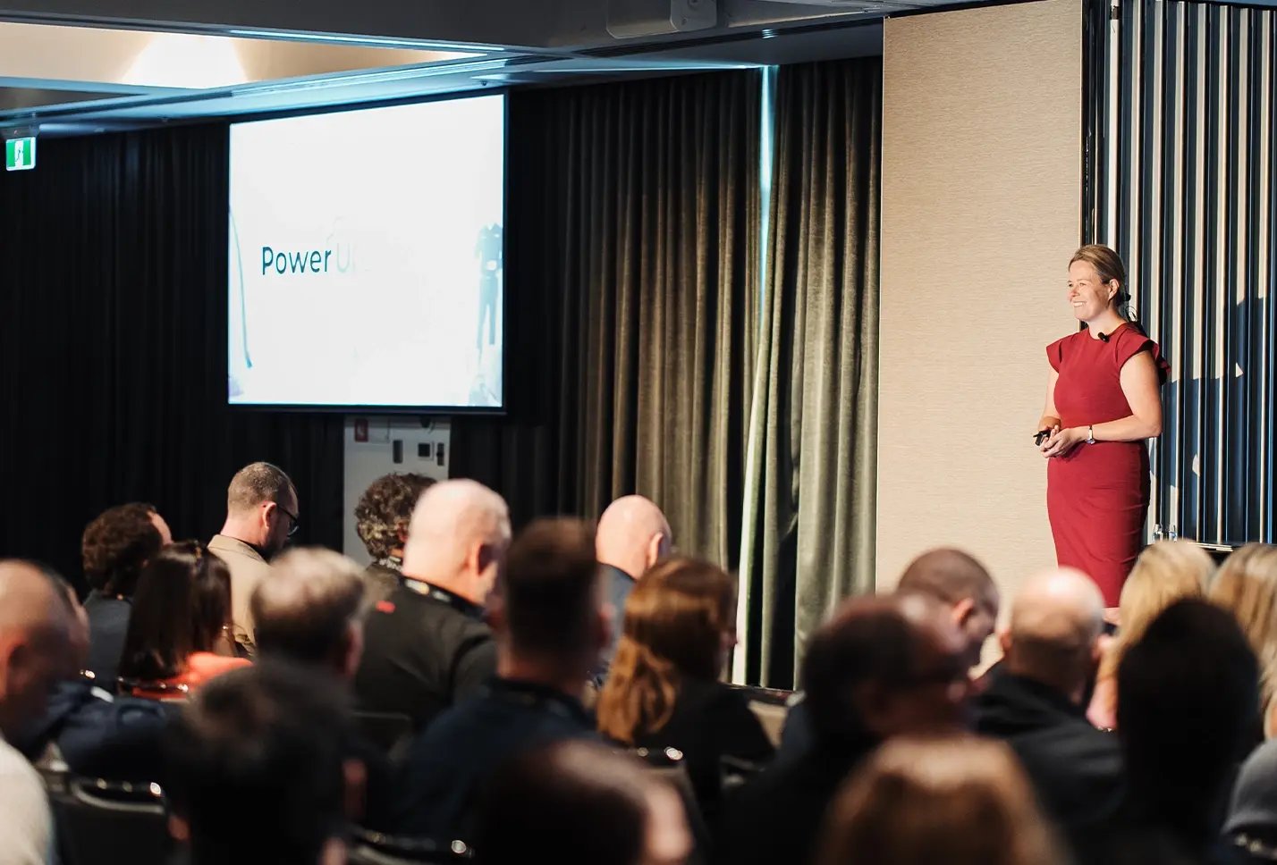 A Dicker Data team member on stage presenting in front of an engaged audience