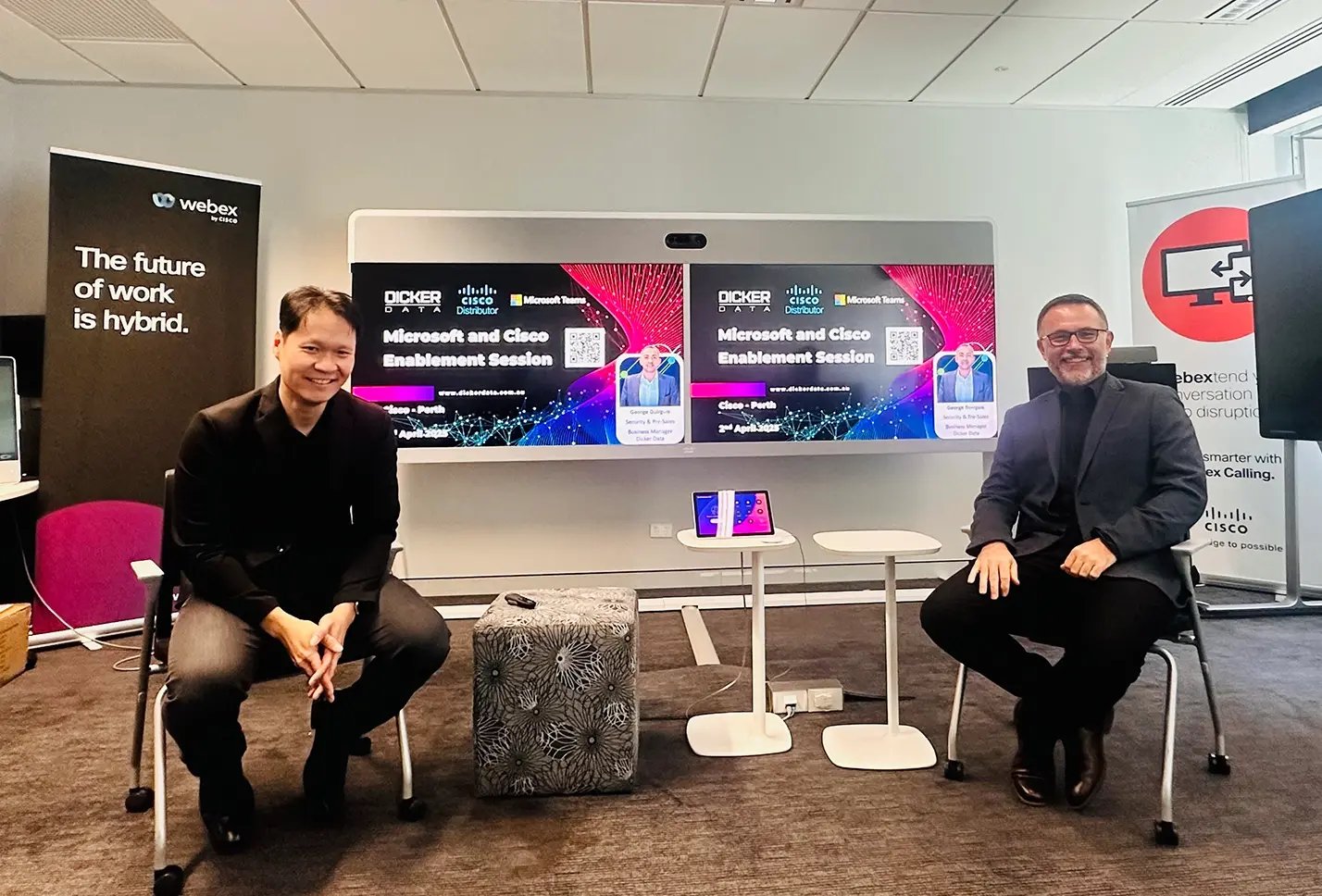 Two Dicker Data team members in a classroom for a hybrid work presentation