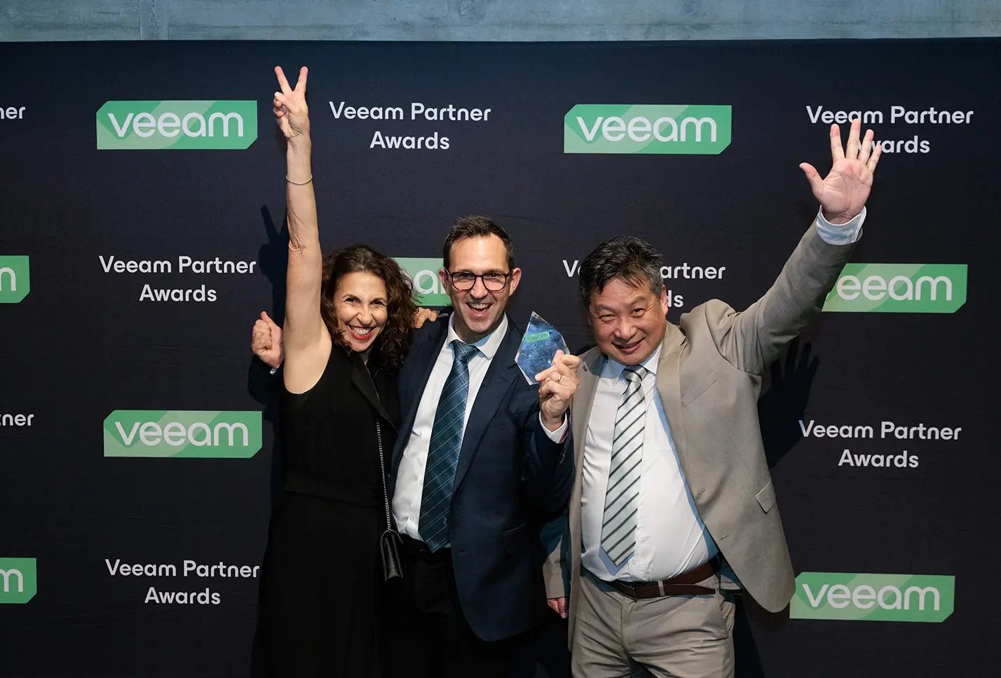 Veeam team in front of media wall