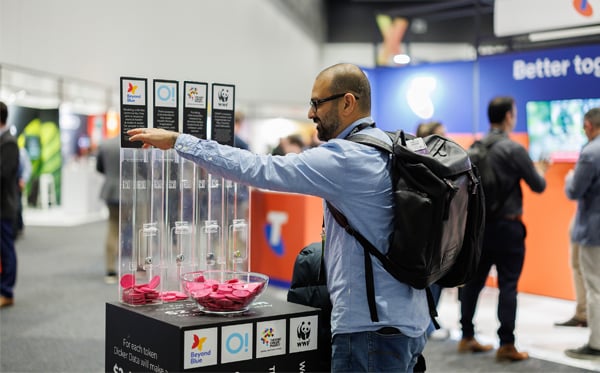  A partner making a donation by placing a coin for their charity of choice