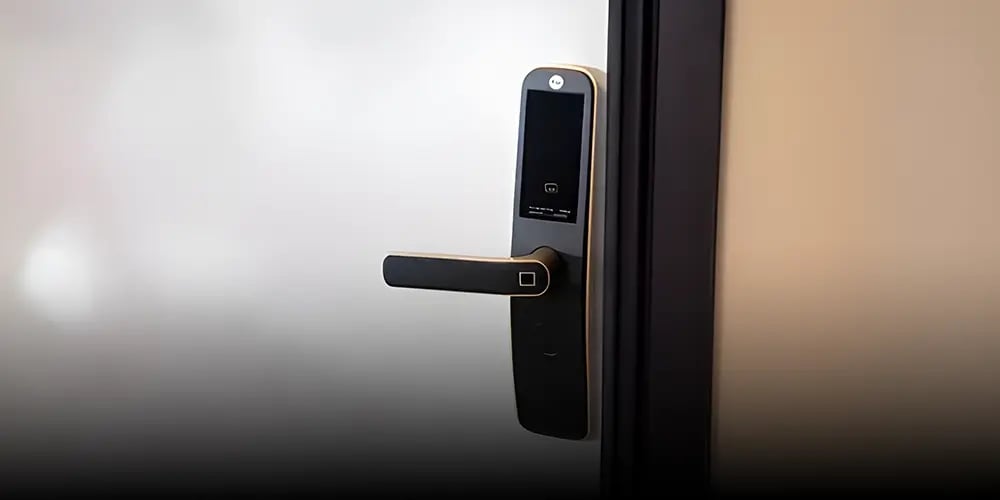 Modern smart door lock on a frosted glass door. The sleek black design features a digital touchscreen and a handle, conveying a futuristic feel.