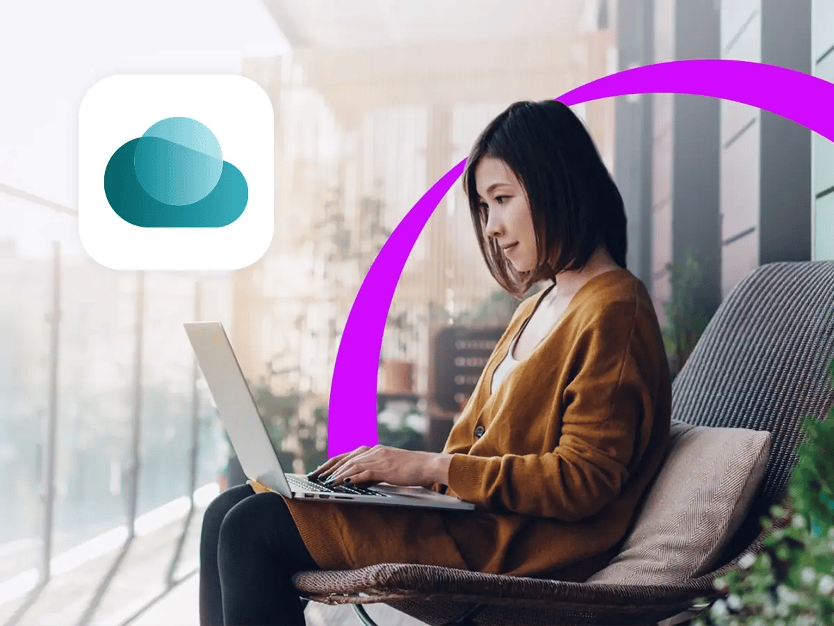 A woman sits outdoors on a cushioned chair, focused on her laptop. A purple arc frames her, with a cloud icon to the left. The scene is calm and modern.