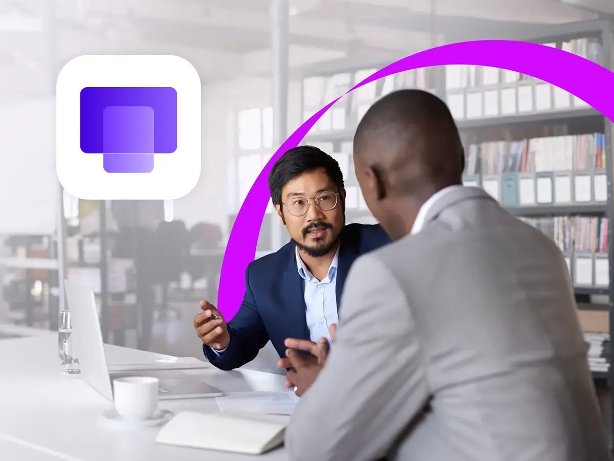 Two men in a modern office engaged in discussion. One wears a blue suit, the other a light gray one. A purple graphic element arcs above them, with a digital logo on the left.