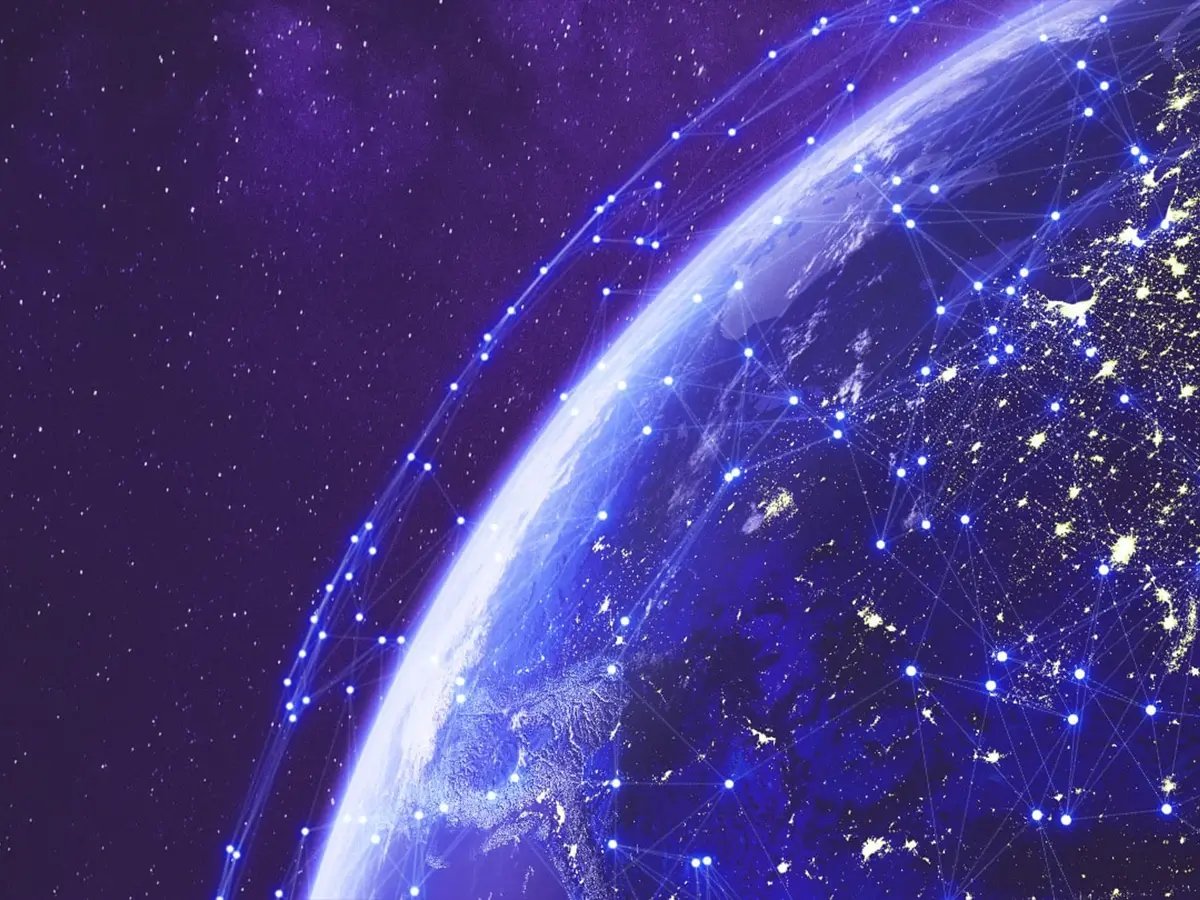 View of Earth from space with glowing blue network lines and connection points over continents, symbolizing global device tracking and connectivity.