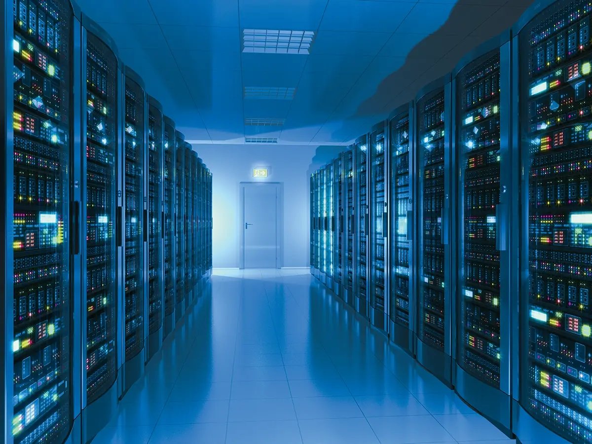 Data center aisle with rows of illuminated server racks representing Eaton power distribution solutions.