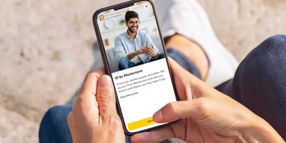 Hands holding a smartphone displaying an app screen with text and an image