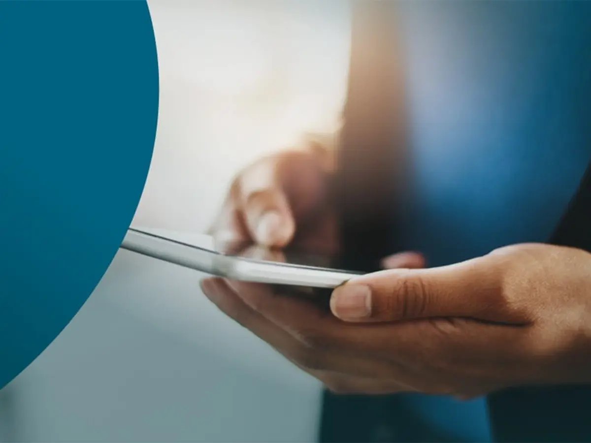 Hands holding a smartphone, representing SMS messaging and mobile communication.