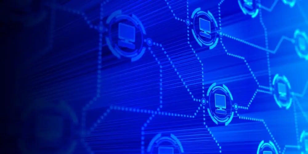 Digital illustration of interconnected computer icons on a blue network grid.