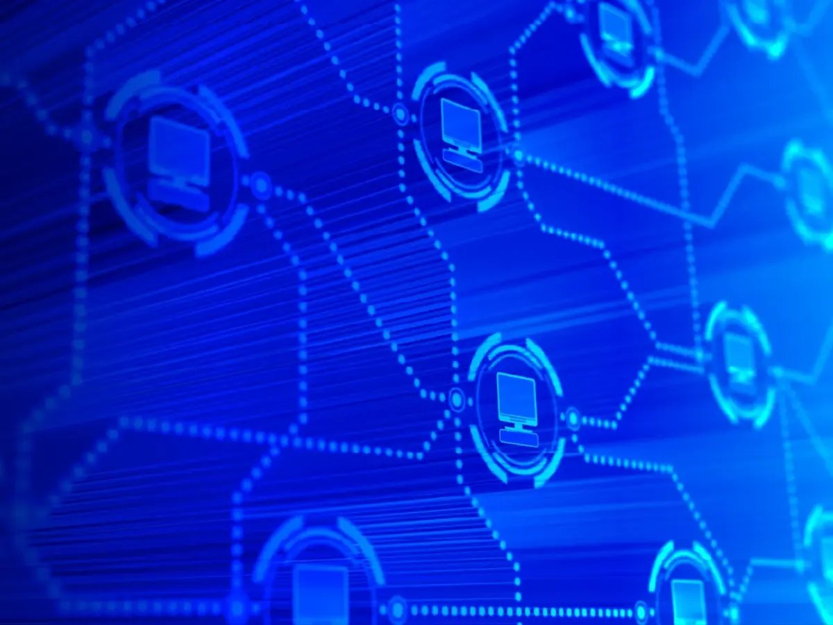 Digital illustration of interconnected computer icons on a blue network grid.