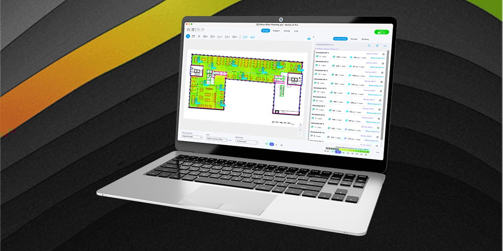 Laptop displaying a detailed Wi‑Fi heatmap and floor plan inside wireless network planning software.