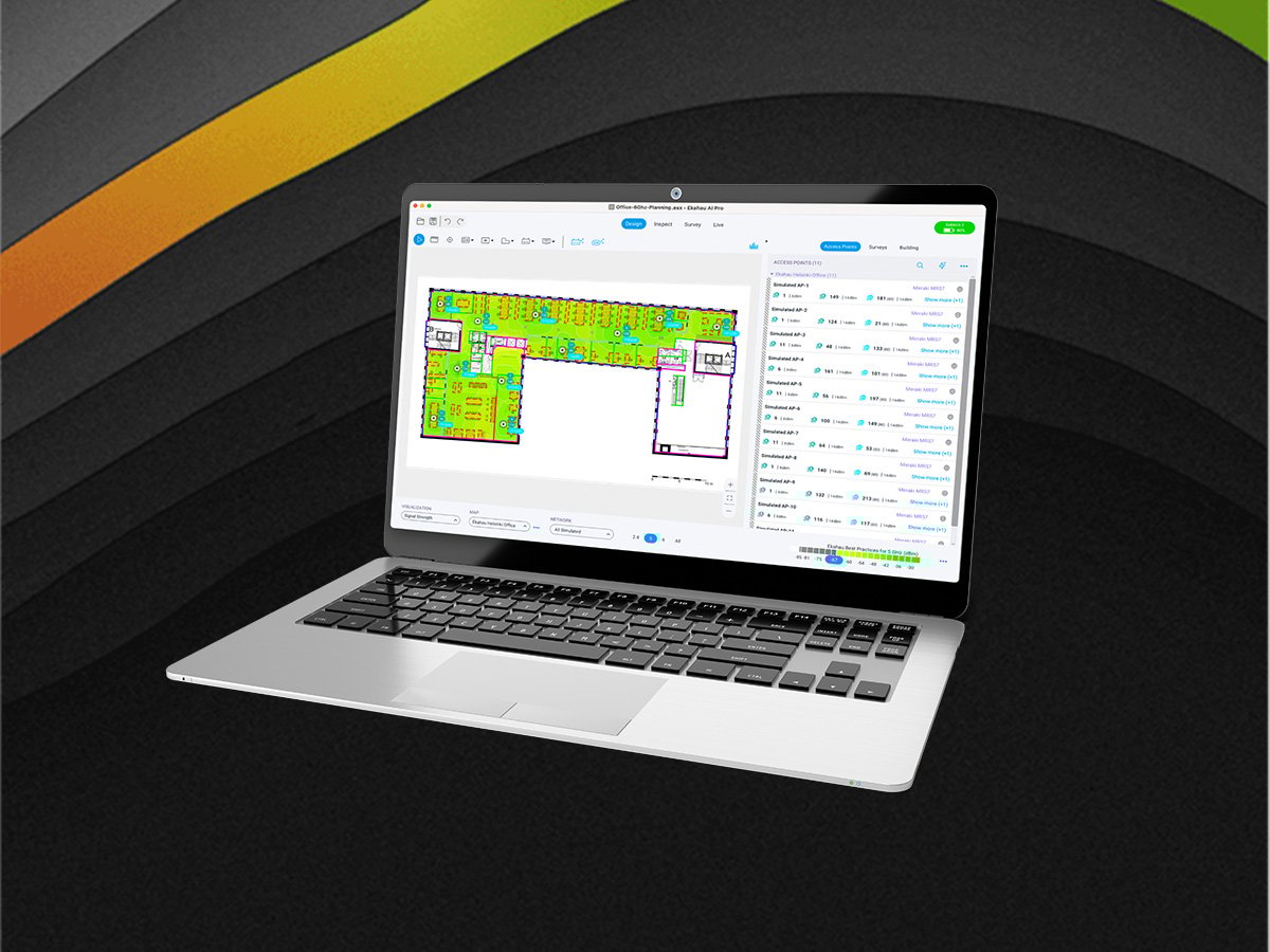 Laptop displaying a detailed Wi‑Fi heatmap and floor plan inside wireless network planning software.