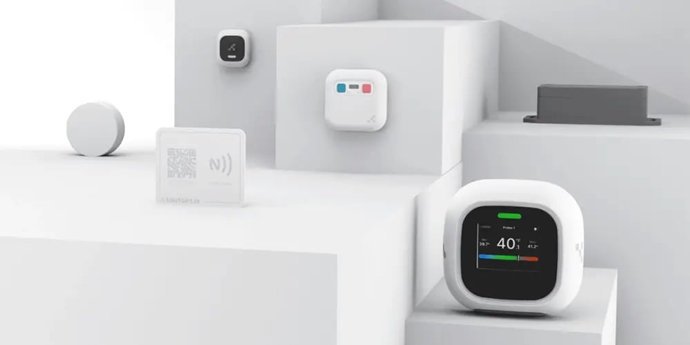 A collection of compact IoT devices arranged on stepped white platforms.