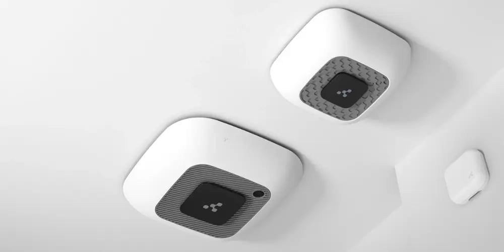 Ceiling-mounted IoT sensors installed in a modern interior space.
