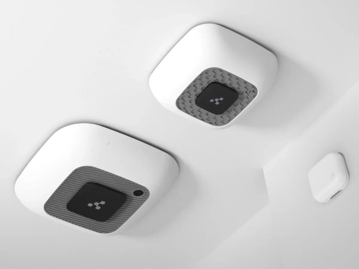 Ceiling-mounted IoT sensors installed in a modern interior space.