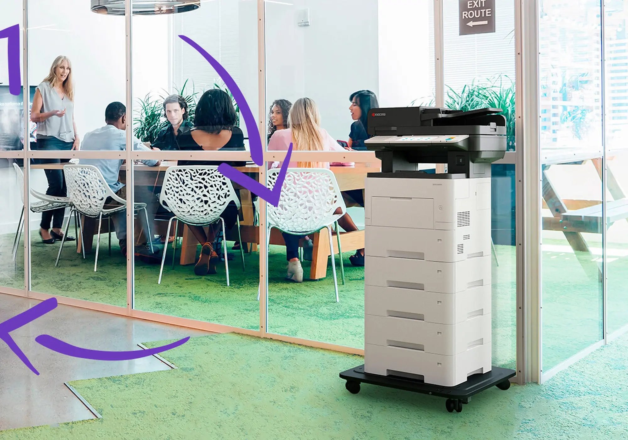 An office setting with people gathered around a wooden conference table in a glass-walled room. A large printer stands outside, with purple arrows pointing to it, emphasizing its presence. The atmosphere is professional and focused.