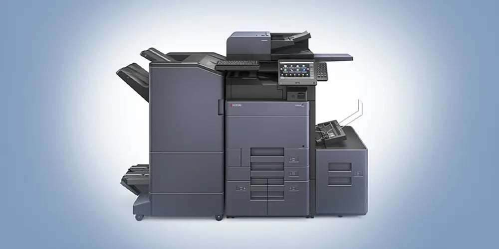 A large, modern multifunction printer with a sleek design. It features multiple trays, a touchscreen panel, and various compartments.