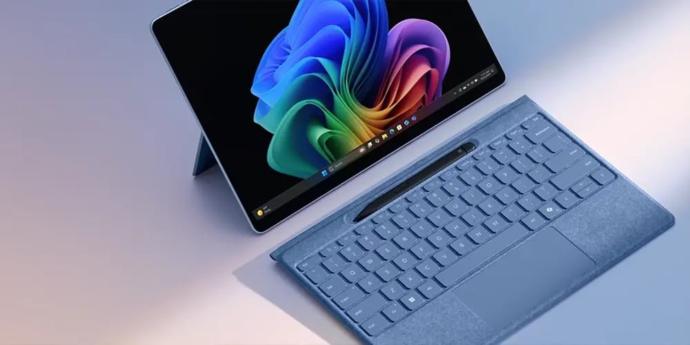 A Surface tablet with a detachable keyboard and a colorful Windows display.