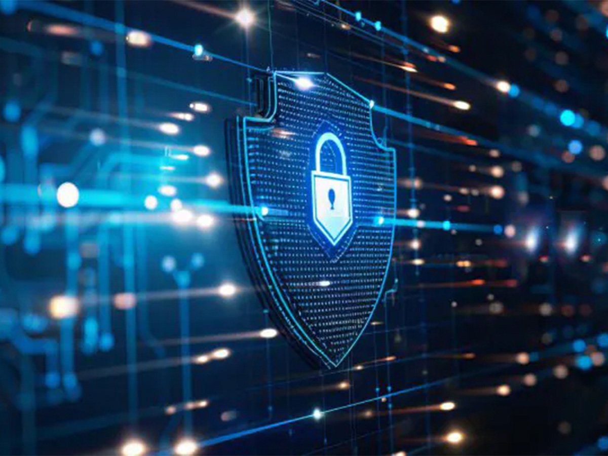 Digital shield with a lock icon over flowing data, representing cybersecurity and data protection.