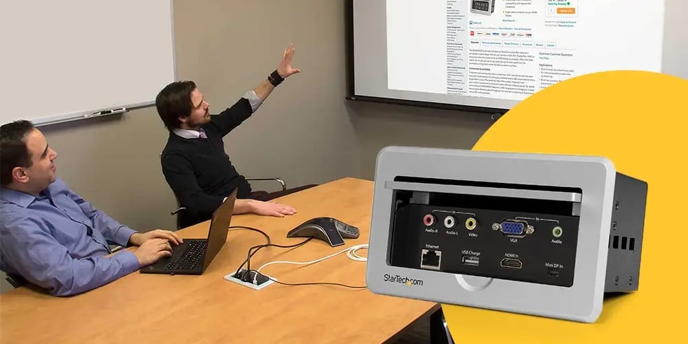 A conference room setup with a StarTech connectivity panel used to link a laptop to a projected display.