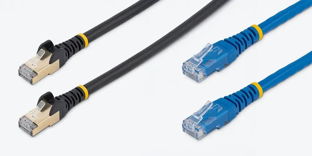Two black shielded Ethernet cables and two blue Ethernet cables laid out side by side.