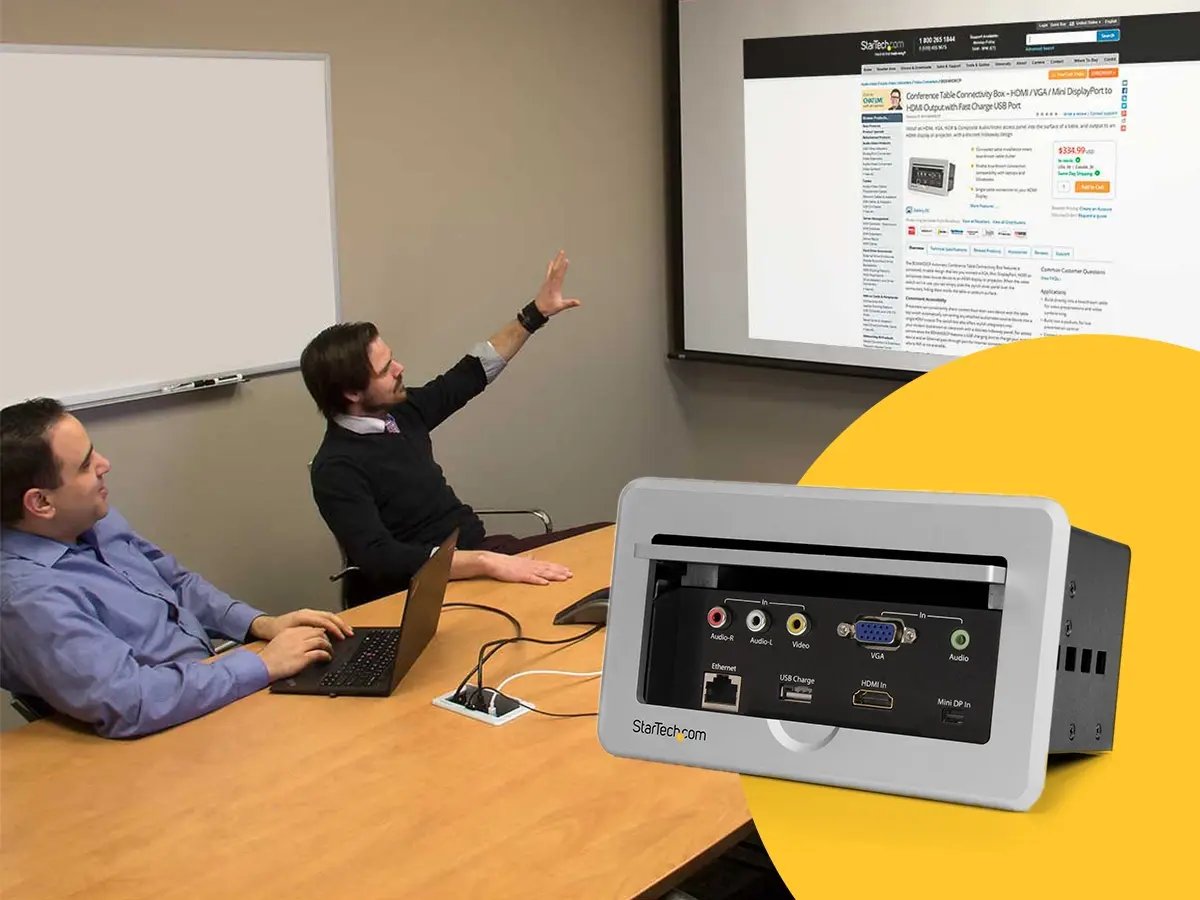 A conference room setup with a StarTech connectivity panel used to link a laptop to a projected display.