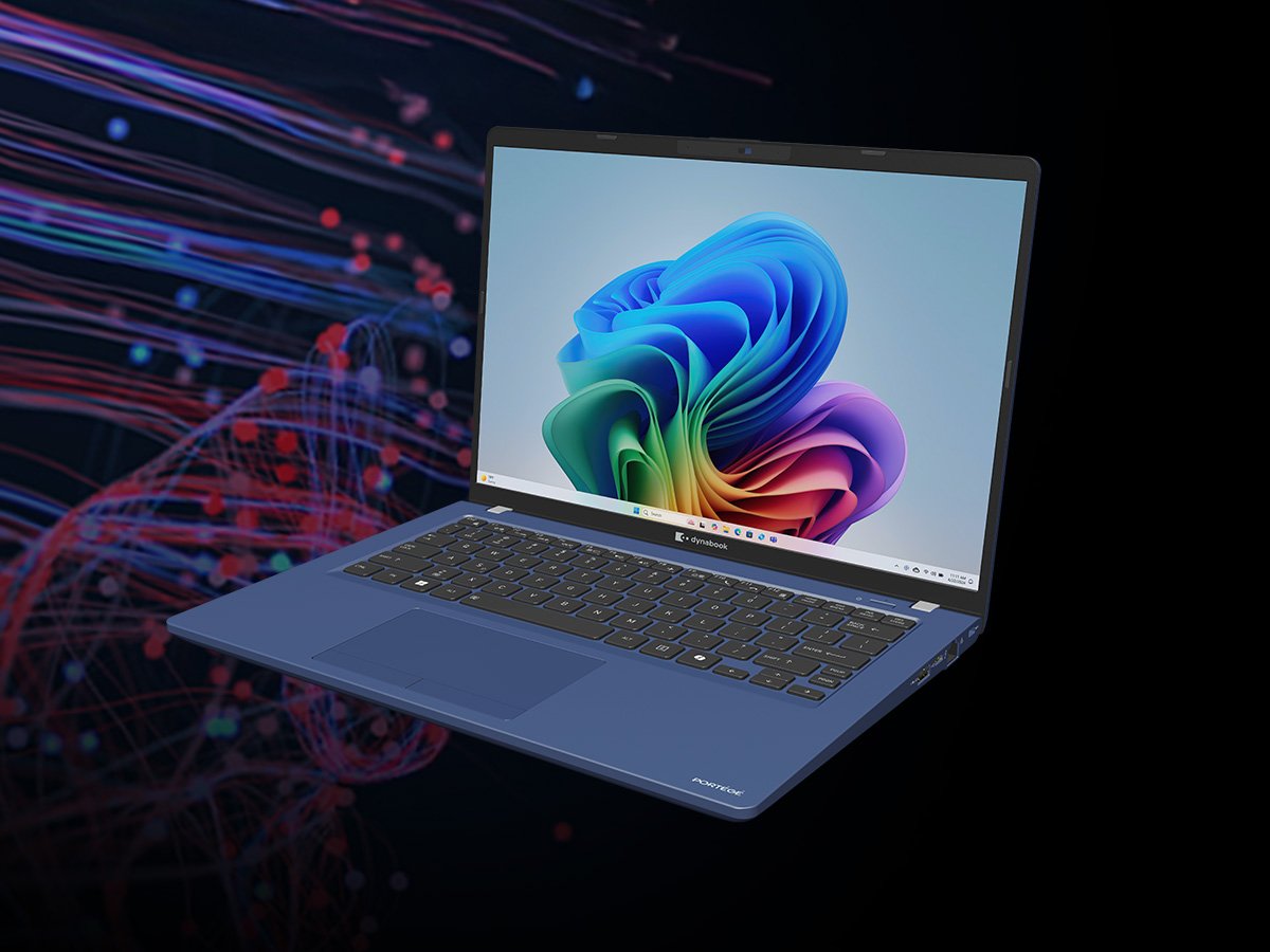Open laptop displaying a colorful abstract desktop wallpaper, shown in a studio setting with data‑style graphics.