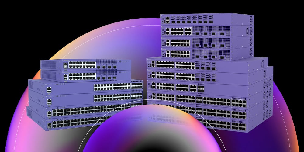 Stacked enterprise network switches with multiple Ethernet ports, shown against a dark gradient background