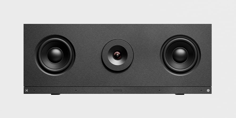 Wide rectangular conference device with two speakers and a central camera lens.