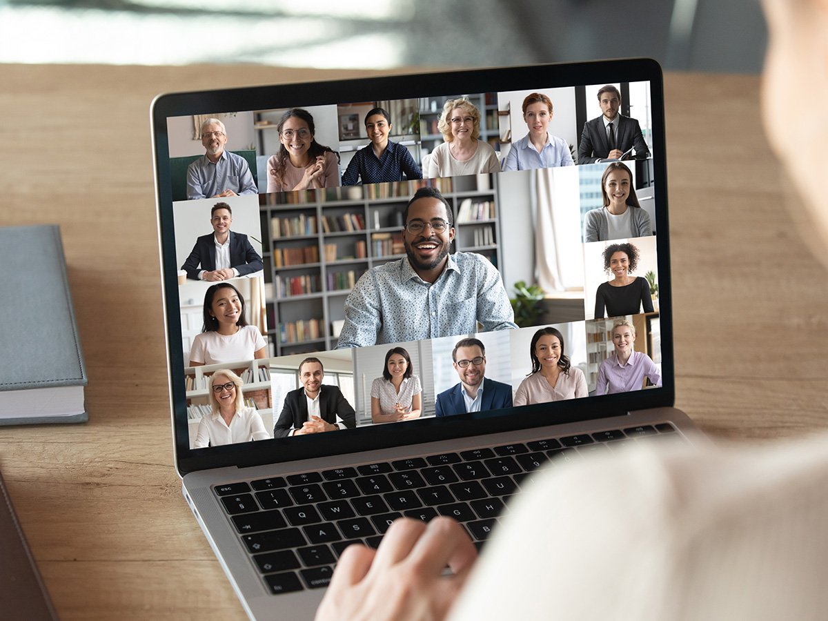 Laptop displaying a grid of participants during a virtual meeting.