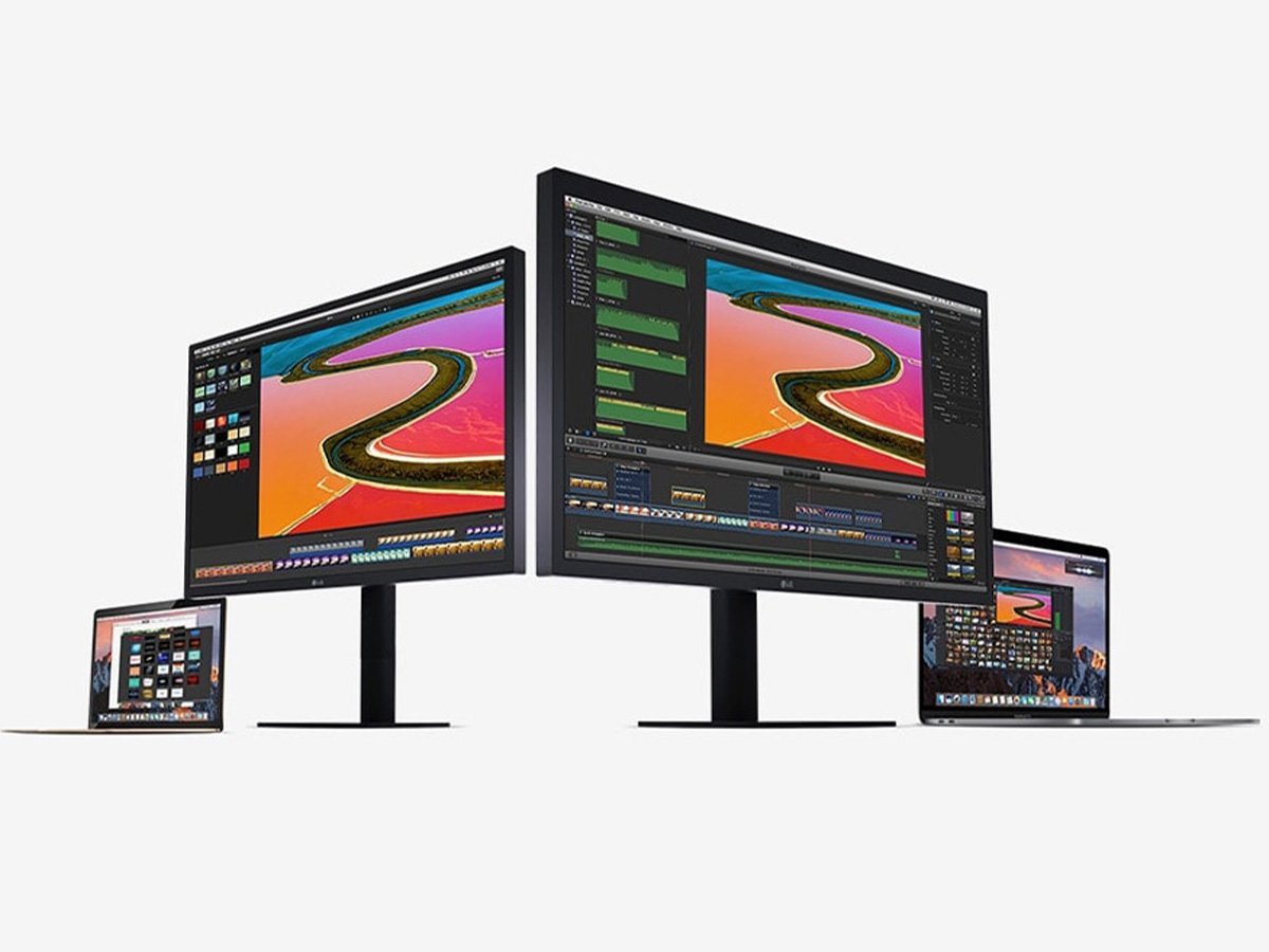 Multiple LG monitors and laptops displaying colourful editing software on a white background.