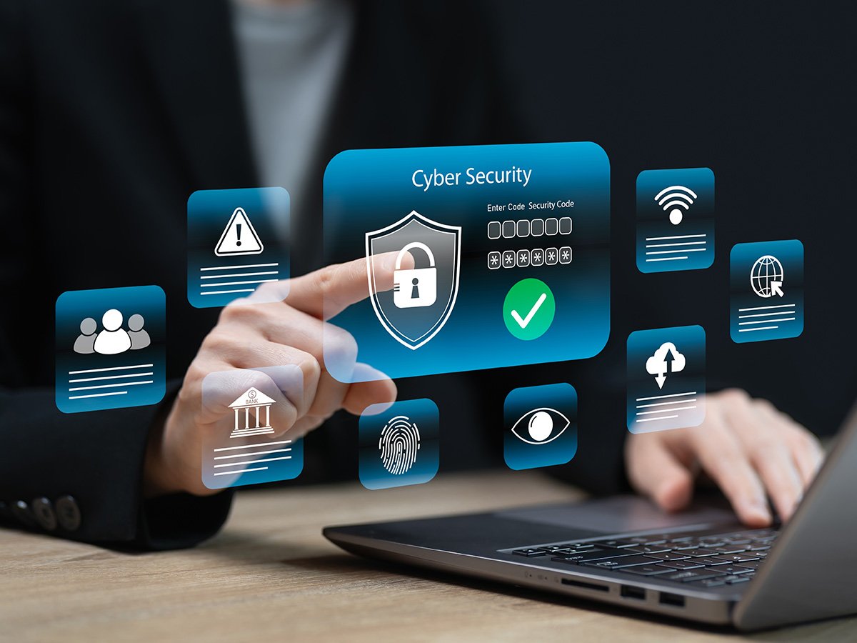 Hand interacting with a virtual cybersecurity dashboard showing a lock icon and security status indicators.