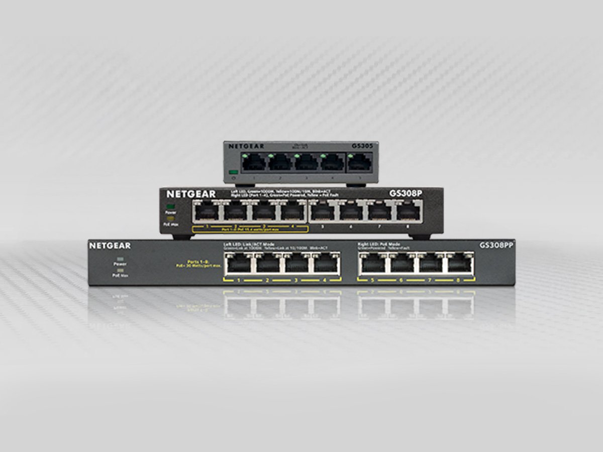 Stack of Netgear network switches with multiple Ethernet ports.